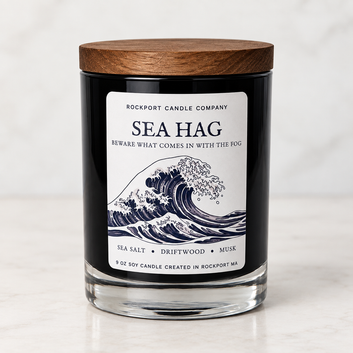 Sea Hag 9 oz soy candle by Rockport Candle Company in a black glass jar with wooden lid, scented with sea salt, driftwood, and musk